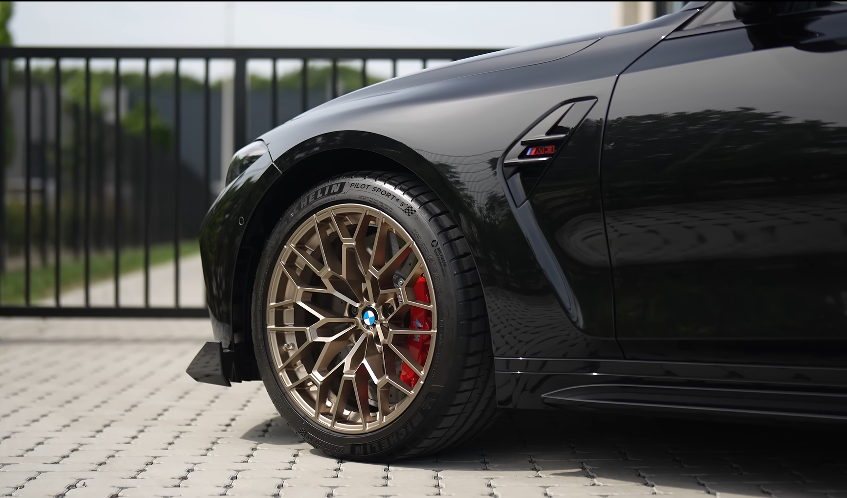 Close view of a clean wheel and tyre on a black BMW